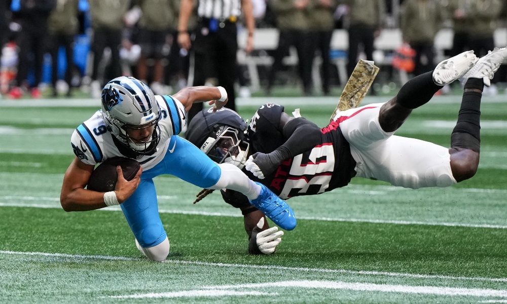 Nov 16, 2025; Atlanta, Georgia, USA; Carolina Panthers quarterback Bryce Young (9) is brought down by Atlanta Falcons inside linebacker Ronnie Harrison (36) in the first quarter at Mercedes-Benz Stadium.