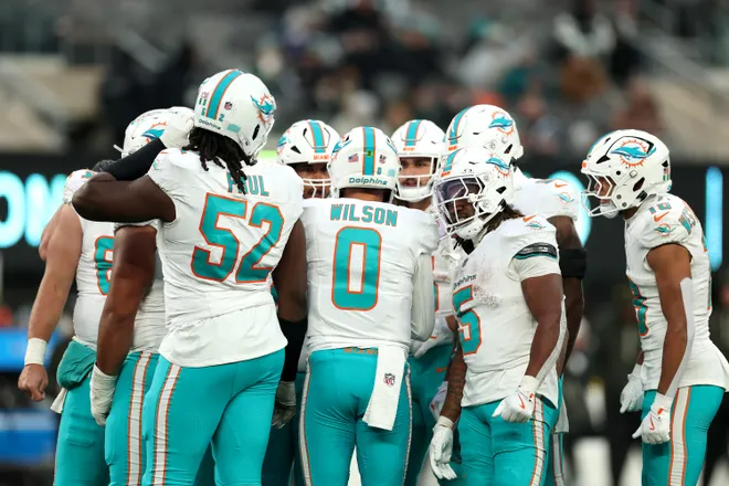 EAST RUTHERFORD, NEW JERSEY - DECEMBER 07: Zach Wilson #0 of the Miami Dolphins leads the offensive huddle during the NFL 2025 game against the New York Jets at MetLife Stadium on December 07, 2025 in East Rutherford, New Jersey."" (Photo by Kenneth Richmond/Getty Images)