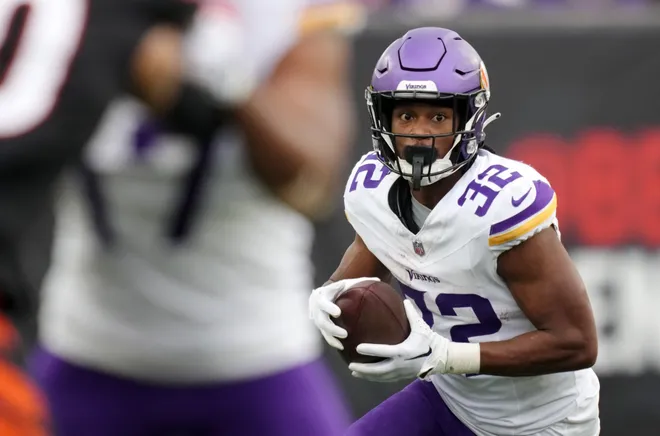 CINCINNATI, OHIO - DECEMBER 16: Ty Chandler #32 of the Minnesota Vikings carries the ball in the third quarter of the game against the Cincinnati Bengals at Paycor Stadium on December 16, 2023 in Cincinnati, Ohio. (Photo by Dylan Buell/Getty Images)