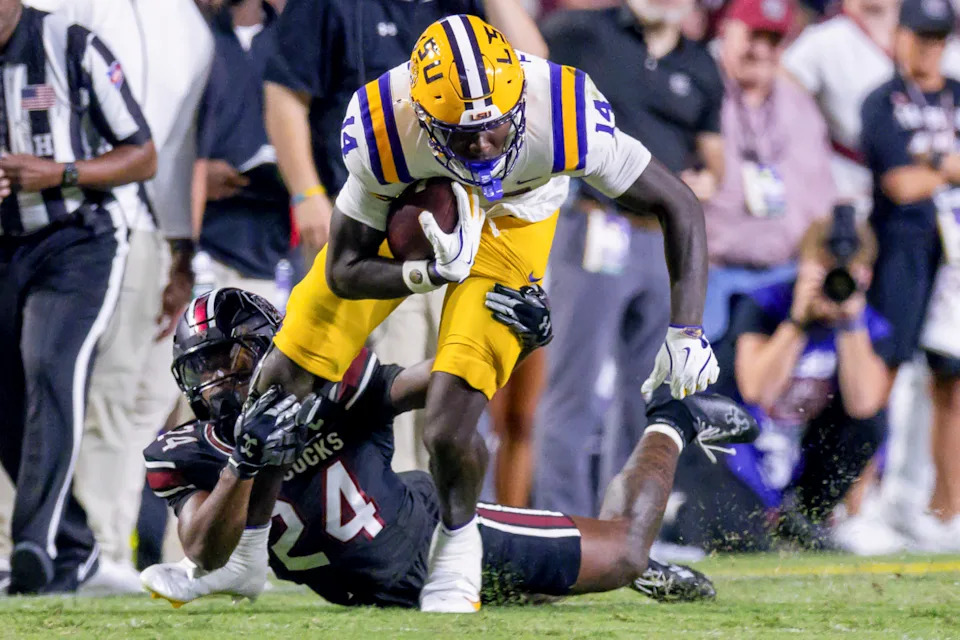 Oct 11, 2025; Baton Rouge, Louisiana, USA; South Carolina Gamecocks defensive back Jalon Kilgore (24) tackles LSU Tigers tight end Trey'Dez Green (14) during the second half at Tiger Stadium.