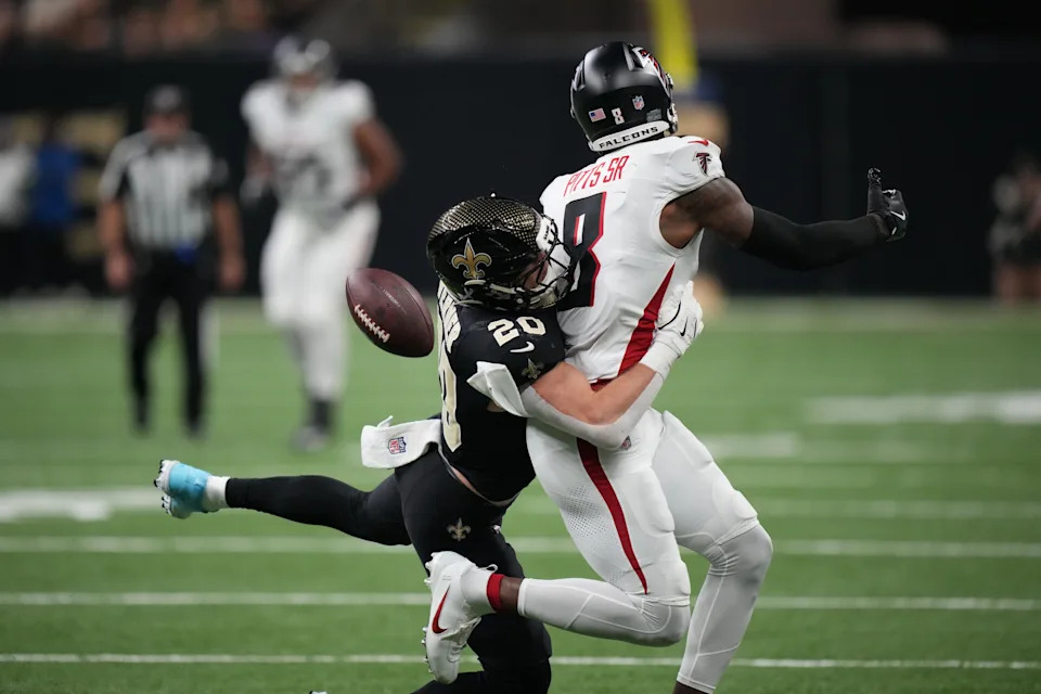 Nov 23, 2025; New Orleans, Louisiana, USA; New Orleans Saints linebacker Pete Werner (20) breaks up the pass to Atlanta Falcons tight end Kyle Pitts Sr. (8) during the first half at Caesars Superdome. Mandatory Credit: Matthew Hinton-Imagn Images