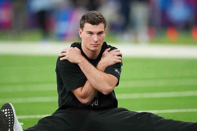 Indiana quarterback Fernando Mendoza (11) runs a drill at the NFL football scouting combine in Indianapolis, Saturday, Feb. 28, 2026. (AP Photo/Julio Cortez)