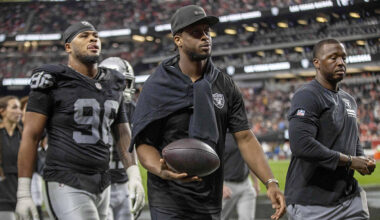 Raiders quarterback Geno Smith (7), center, walks off the field for halftime an NFL game agains ...