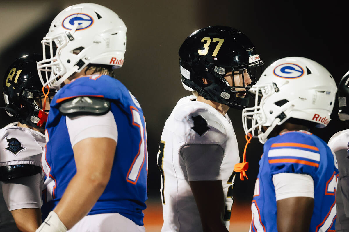 Players shake hands during a line up after Lone Peak was forced to forfeit a high school footba ...