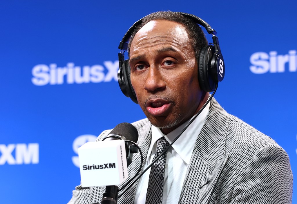 Stephen A. Smith wearing headphones and speaking into a SiriusXM microphone.