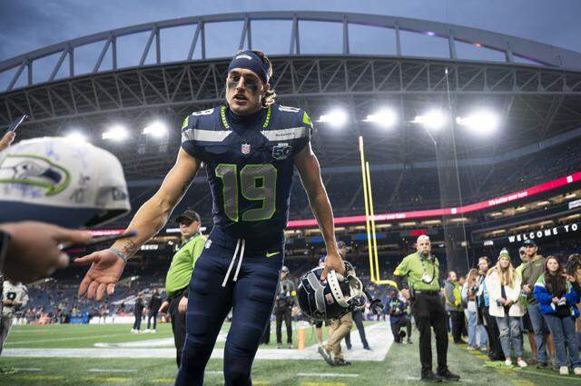 Seattle Seahawks wide receiver Jake Bobo (19) high-fives fans before the game against the Houston Texans at Lumen Field, on Monday, Oct. 20, 2025, in Seattle.