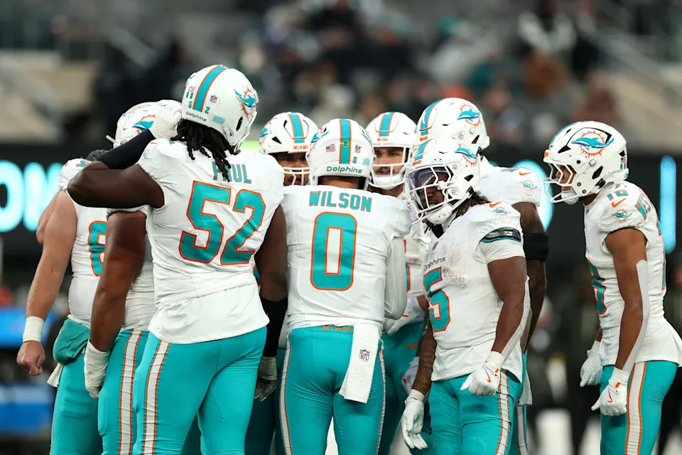 EAST RUTHERFORD, NEW JERSEY - DECEMBER 07: Zach Wilson #0 of the Miami Dolphins leads the offensive huddle during the NFL 2025 game against the New York Jets at MetLife Stadium on December 07, 2025 in East Rutherford, New Jersey."" (Photo by Kenneth Richmond/Getty Images)