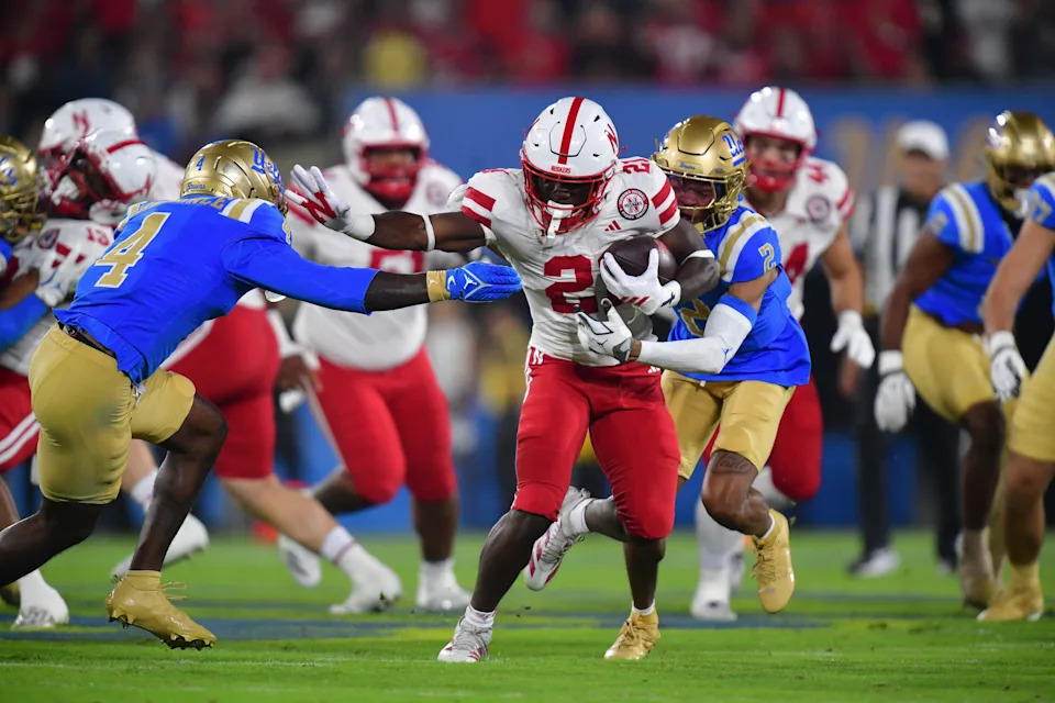 Nov 8, 2025; Pasadena, California, USA; Nebraska Cornhuskers running back Emmett Johnson (21) runs the ball against the UCLA Bruins during the first half at the Rose Bowl. Mandatory Credit: Gary A. Vasquez-Imagn Images