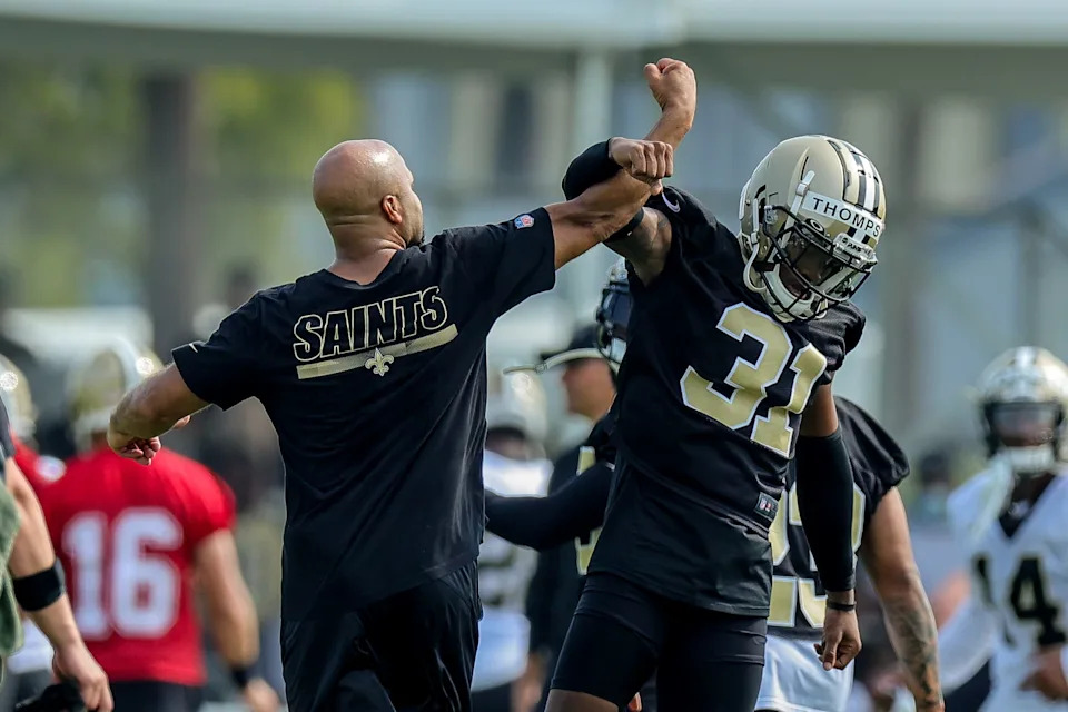 Jul 31, 2021; Metairie, LA, USA; New Orleans Saints assistant strength and conditioning coach Charles Byrd slaps hands with cornerback Bryce Thompson (31) during a New Orleans Saints training camp session at the New Orleans Saints Training Facility. Mandatory Credit: Stephen Lew-USA TODAY Sports