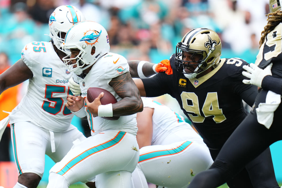 Miami Dolphins quarterback Tua Tagovailoa is pressured by New Orleans Saints defensive end Cameron Jordan on Nov. 30, 2025Rich Storry-Imagn Images