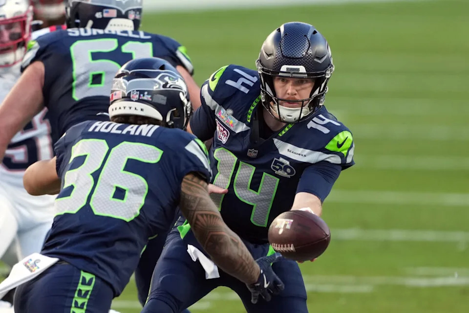 Feb 8, 2026; Santa Clara, CA, USA; Seattle Seahawks quarterback Sam Darnold (14) hands off to running back George Holani (36) during the first quarter against the New England Patriots in Super Bowl LX at Levi’s Stadium. Mandatory Credit: Darren Yamashita-Imagn Images