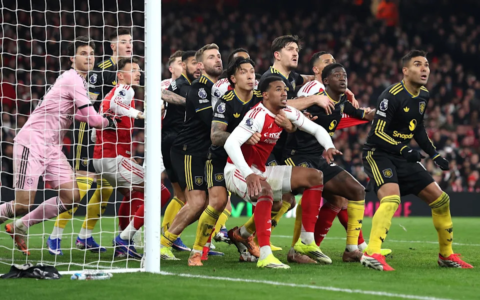 Gabriel of Arsenal is held by Lisandro Martinez of Manchester United for an oncoming corner during the Premier League match between Arsenal and Manchester United