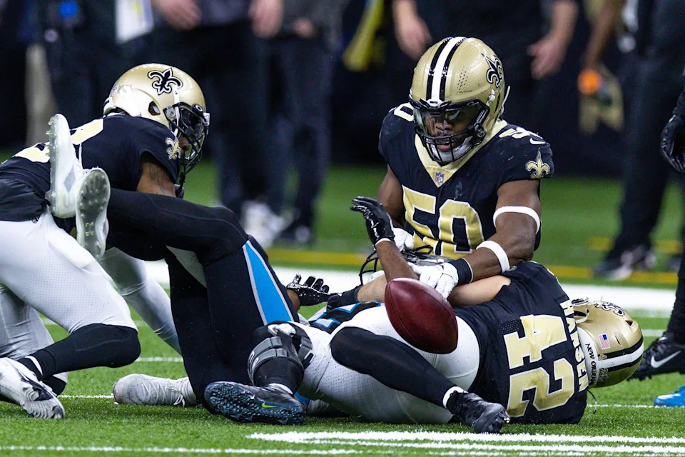 Jan 8, 2023; New Orleans, Louisiana, USA; Carolina Panthers wide receiver Andre Roberts (18) fumbles the ball against New Orleans Saints cornerback Marshon Lattimore (23) and linebacker Andrew Dowell (50) and linebacker Chase Hansen (42) during the second half at Caesars Superdome. Mandatory Credit: Stephen Lew-USA TODAY Sports