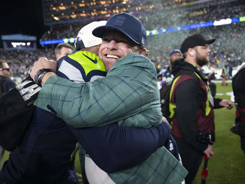 Seattle Seahawks general manager John Schneider hugs Seattle Seahawks running back Kenneth Walker III (9) after beating the New England Patriots 29-13 in Super Bowl LX at Levi's Stadium on Sunday, Feb. 8, 2026, in Santa Clara, Calif.