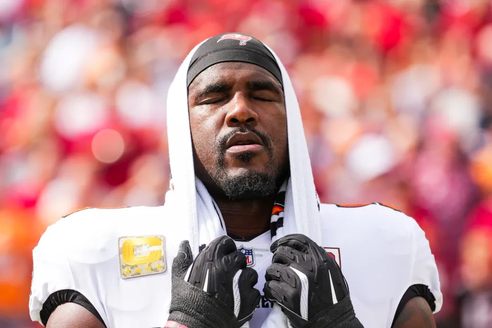 Lavonte David #54 of the Tampa Bay Buccaneers looks on from the sideline during the nationan anthem prior to an NFL football game against the New England Patriots at Raymond James Stadium on November 9, 2025 in Tampa, Florida.