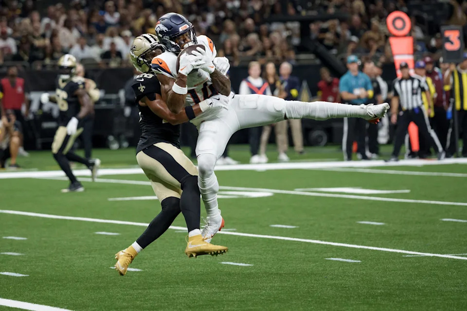 Aug 23, 2025; New Orleans, Louisiana, USA; Denver Broncos wide receiver Courtland Sutton (14) makes a touchdown reception against New Orleans Saints safety Julian Blackmon (28) during the first half at Caesars Superdome. Mandatory Credit: Matthew Hinton-Imagn Images
