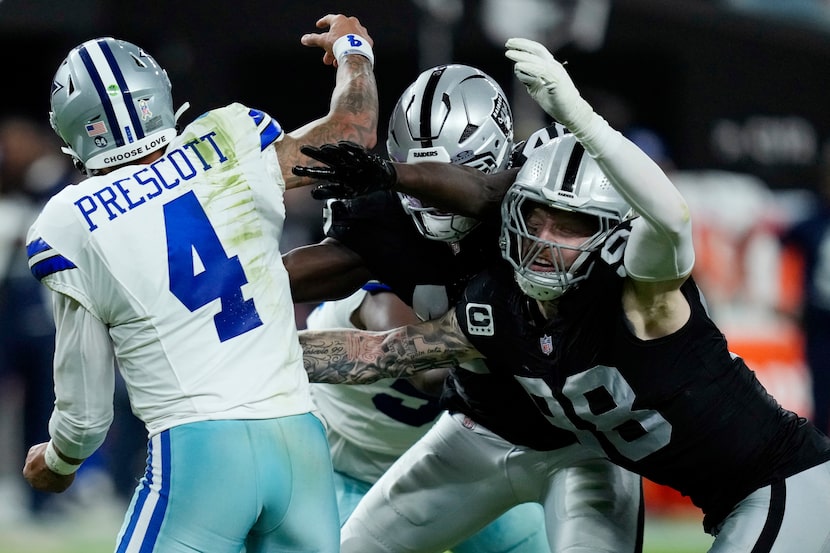 Las Vegas Raiders defensive end Maxx Crosby and Raiders linebacker Jamin Davis puts pressure...