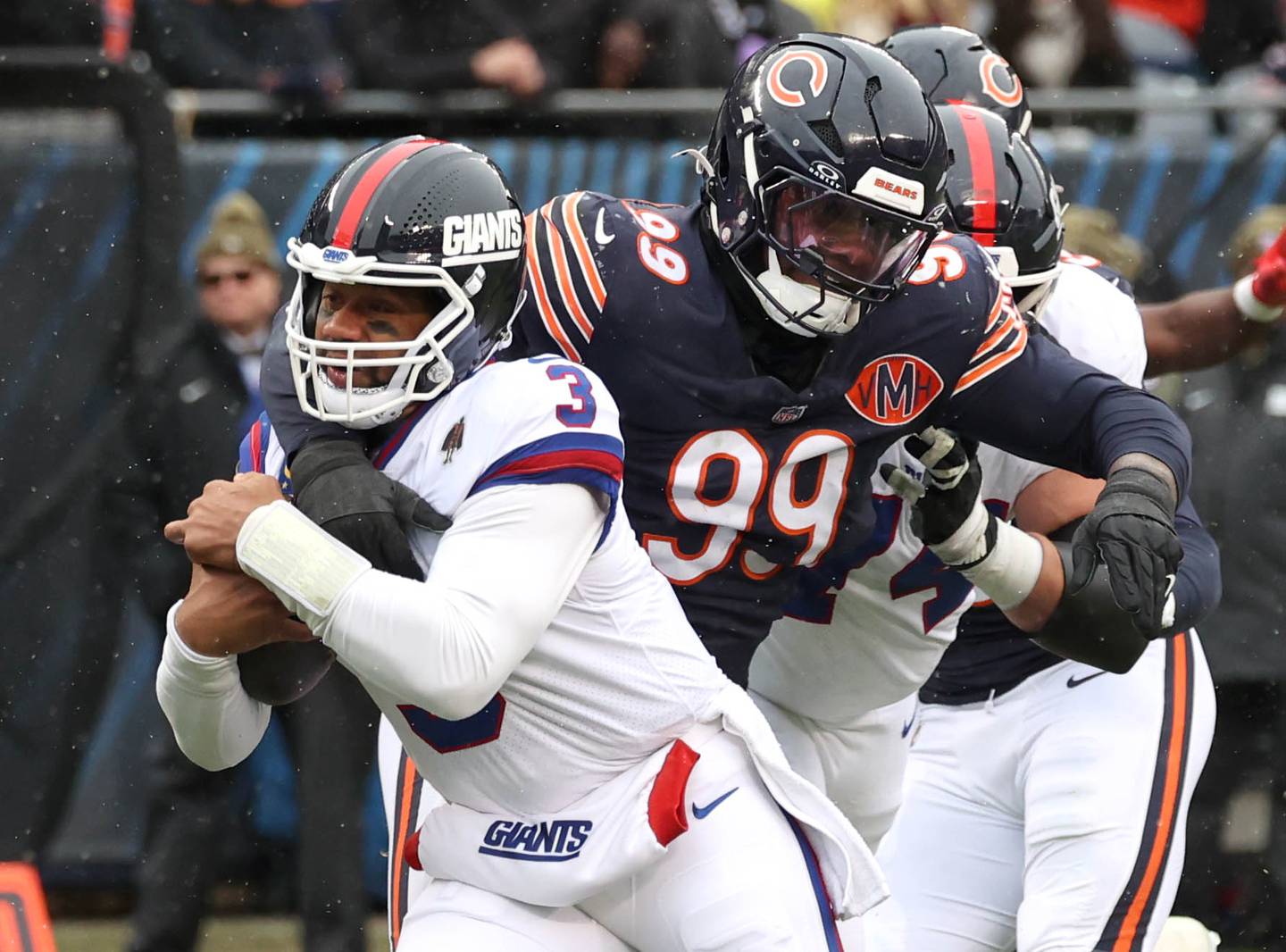 Chicago Bears defensive tackle Gervon Dexter Sr. wraps up New York Giants quarterback Russell Wilson after a short gain Sunday, Nov. 9, 2025, during their game at Soldier Field in Chicago.