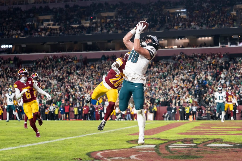 Dallas Goedert (88) completes a catch against Quan Martin (20) of the Washington Commanders for a touchdown during an NFL football game at Northwest Stadium on December 20, 2025 in Landover, Maryland. Getty Images