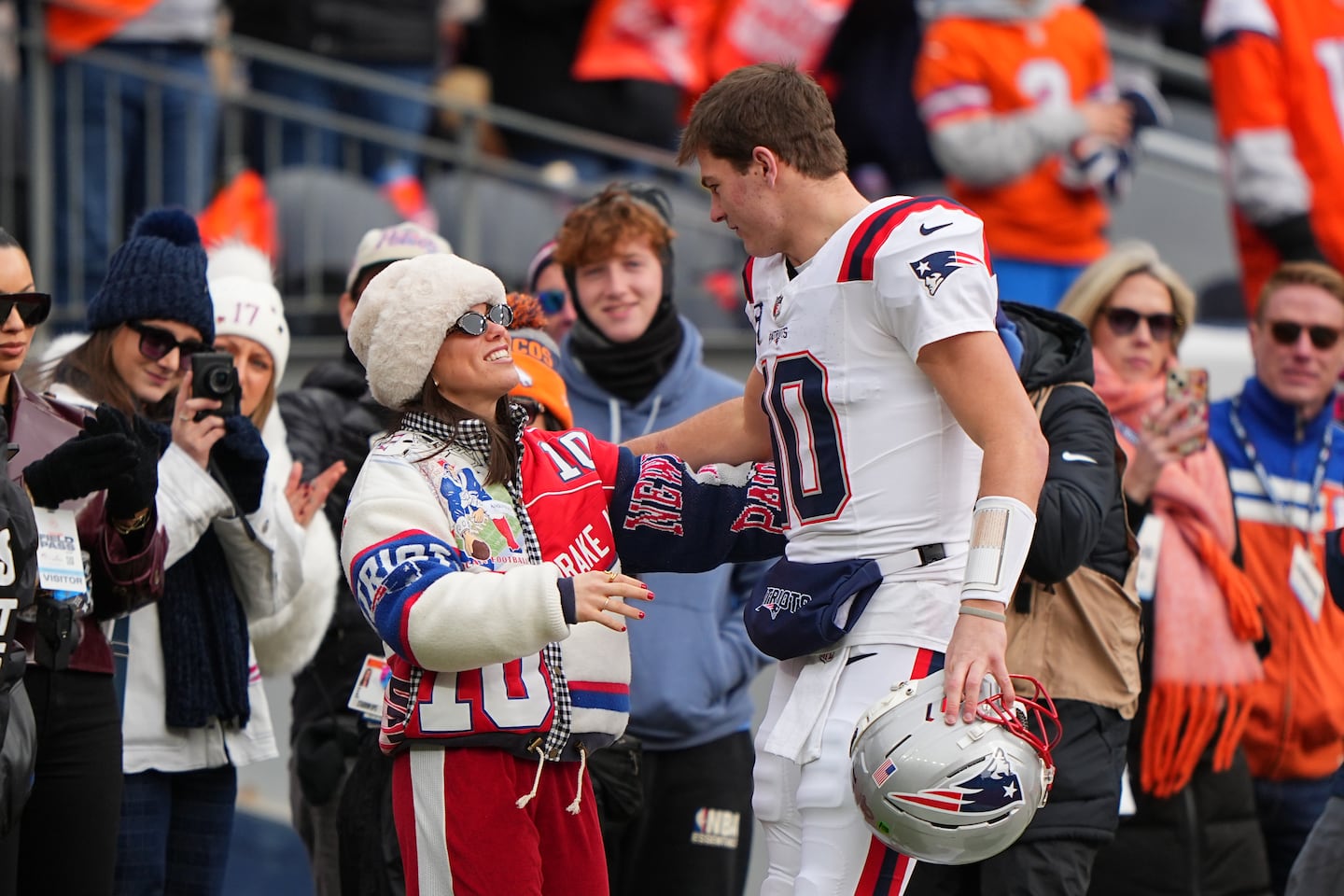 Ann Michael Maye greets New England Patriots quarterback Drake Maye before the AFC Championship game against the Denver Broncos.
