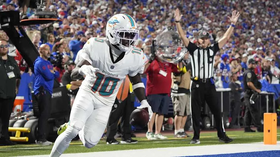Hill scores a touchdown against the Buffalo Bills in the fourth quarter at Highmark Stadium. 