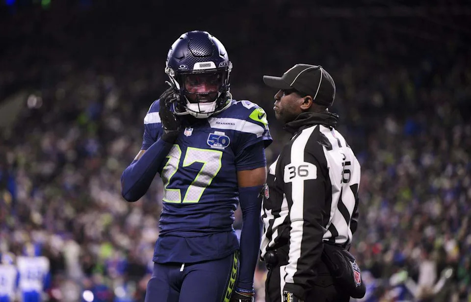 Seattle Seahawks cornerback Riq Woolen (27) comes off the field as a ref talks to him during the fourth quarter of the NFC Championship game against the Los Angeles Rams at Lumen Field, on Sunday, Jan. 25, 2026, in Seattle.