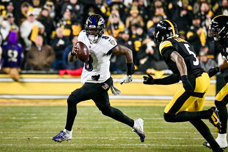 Baltimore Ravens quarterback Lamar Jackson keeps for a first down in the first quarter as the Ravens play the Pittsburgh Steelers at Acrisure Stadium in Pittsburgh, Penn., on Sunday.
