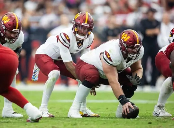 Sep 29, 2024; Glendale, Arizona, USA; Washington Commanders center Tyler Biadasz (63) prepares to snap the ball to quarterback Jayden Daniels (5) against the Arizona Cardinals at State Farm Stadium. Mandatory Credit: Mark J. Rebilas-Imagn Images