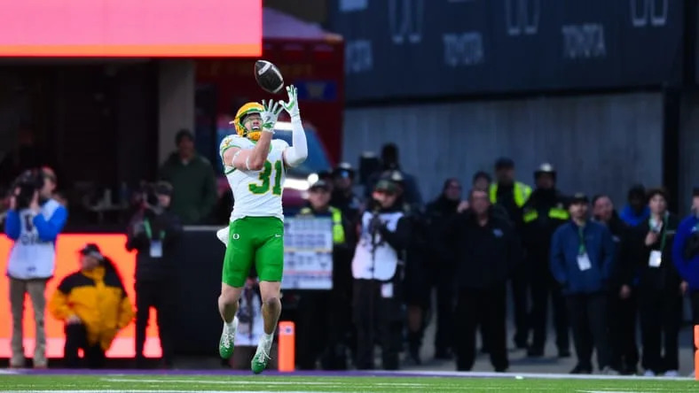 Nov 29, 2025; Seattle, Washington, USA; Oregon Ducks defensive back Dillon Thieneman (31) intercepts a pass against the Washington Huskies during the second half at Husky Stadium. Mandatory Credit: Steven Bisig-Imagn Images