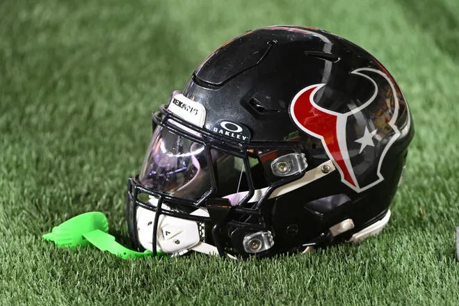 A Houston Texans helmet sits on the sidelines.