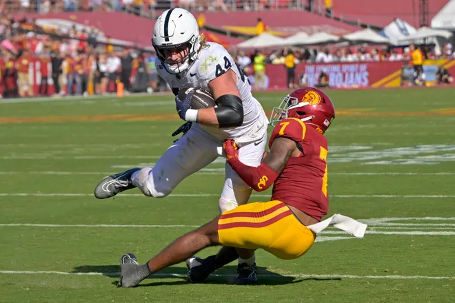 Oct 12, 2024; Los Angeles, California, USA; Penn State Nittany Lions tight end Tyler Warren (44) is stopped by USC Trojans safety Kamari Ramsey (7) after a short gain in the second half at United Airlines Field at the Los Angeles Memorial Coliseum. Mandatory Credit: Jayne Kamin-Oncea-Imagn Images