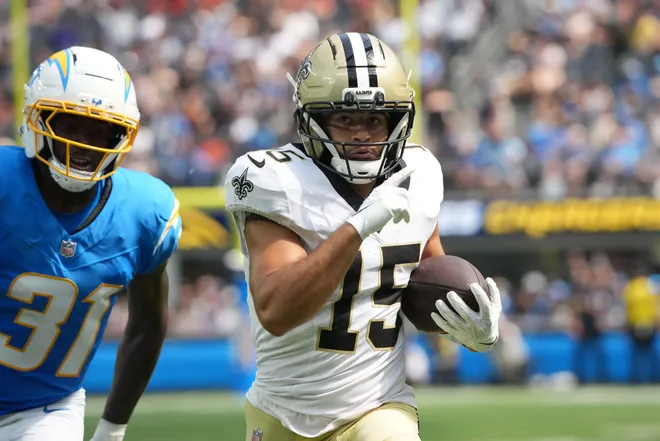 Aug 10, 2025; Inglewood, California, USA; New Orleans Saints wide receiver Mason Tipton (15) scores on a 53-yard touchdown reception against Los Angeles Chargers safety Trikweze Bridges (31) in the third quarter at SoFi Stadium. Mandatory Credit: Kirby Lee-Imagn Images