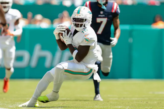 Sep 14, 2025; Miami Gardens, Florida, USA; Miami Dolphins wide receiver Tyreek Hill (10) catches the football against the New England Patriots during the second quarter at Hard Rock Stadium. Mandatory Credit: Sam Navarro-Imagn Images