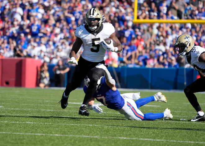 Sep 28, 2025; Orchard Park, New York, USA; New Orleans Saints running back Kendre Miller (5) is tackled by Buffalo Bills cornerback Taron Johnson (7) during the fourth quarter at Highmark Stadium. Mandatory Credit: Gregory Fisher-Imagn Images