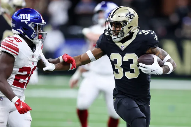 Oct 5, 2025; New Orleans, Louisiana, USA; New Orleans Saints safety Jonas Sanker (33) runs with the ball after a fumble against New York Giants running back Devin Singletary (26) during the first half at Caesars Superdome. Mandatory Credit: Stephen Lew-Imagn Images