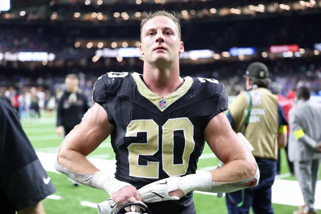 New Orleans Saints linebacker Pete Werner takes off his gloves as he walks off the field after their win against the New York Giants.