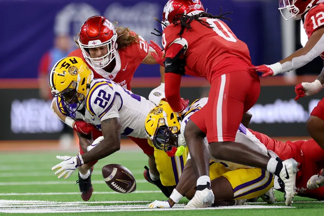 HOUSTON, TEXAS - DECEMBER 27: Wrook Brown #24 of the Houston Cougars tackles Harlem Berry #22 of the Louisiana State Tigers forcing a fumble in the first half during the Kinder's Texas Bowl at NRG Stadium on December 27, 2025 in Houston, Texas. (Photo by Tim Warner/Getty Images)