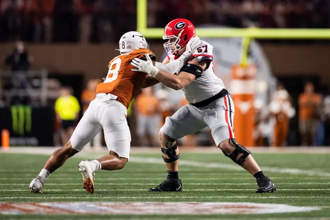 Oct 19, 2024; Austin, Texas, USA; Georgia Bulldogs offensive lineman Monroe Freeling (57) blocks Texas Longhorns edge rusher Trey Moore (8) in the second quarter at Darrell K Royal-Texas Memorial Stadium. Mandatory Credit: Brett Patzke-Imagn Images
