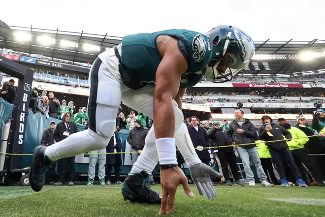 Jan 11, 2026; Philadelphia, PA, USA; Philadelphia Eagles quarterback Jalen Hurts (1) touches the grass as he heads out to the field for warmups prior to an NFC Wild Card Round game against the San Francisco 49ers at Lincoln Financial Field. Mandatory Credit: Bill Streicher-Imagn Images