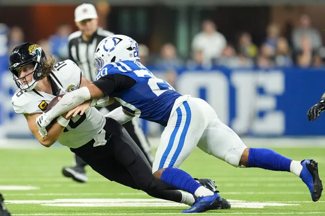 Indianapolis Colts safety Nick Cross (20) wraps up Jacksonville Jaguars quarterback Trevor Lawrence (16) on Sunday, Dec. 28, 2025, during a game at Lucas Oil Stadium in Indianapolis.