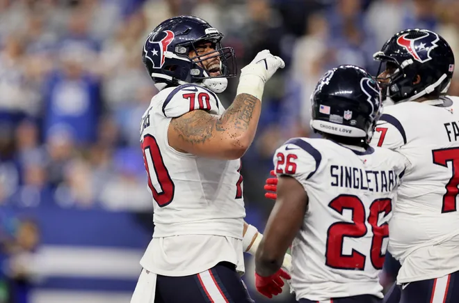 INDIANAPOLIS, INDIANA - JANUARY 06: Juice Scruggs #70 and Devin Singletary #26 of the Houston Texans celebrate a touchdown in the game against the Indianapolis Colts at Lucas Oil Stadium on January 06, 2024 in Indianapolis, Indiana. (Photo by Andy Lyons/Getty Images)