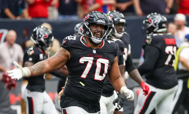 Sep 29, 2024; Houston, Texas, USA; Houston Texans center Juice Scruggs (70) celebrates a Texans running back Dare Ogunbowale (33) touchdown against the Jacksonville Jaguars in the second half at NRG Stadium. Mandatory Credit: Thomas Shea-Imagn Images