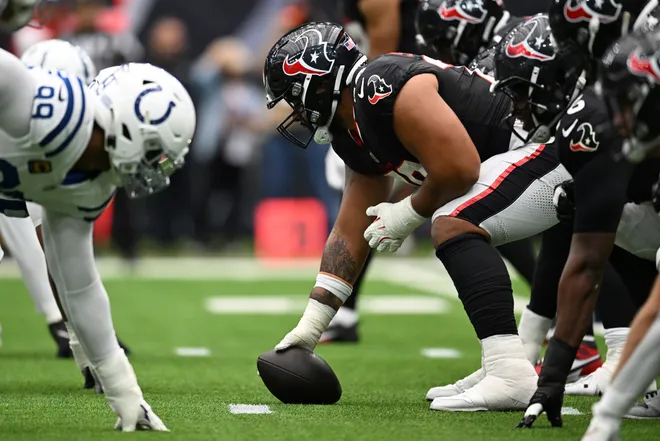 HOUSTON, TEXAS - OCTOBER 27: Juice Scruggs #70 of the Houston Texans prepares to snap the ball during the first quarter against the Indianapolis Colts at NRG Stadium on October 27, 2024 in Houston, Texas. (Photo by Jack Gorman/Getty Images)