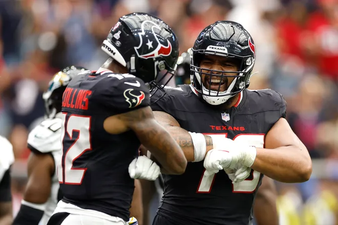 HOUSTON, TEXAS - SEPTEMBER 29: Nico Collins #12 of the Houston Texans celebrates a second quarter touchdown against the Jacksonville Jaguars with teammate Juice Scruggs #70 at NRG Stadium on September 29, 2024 in Houston, Texas. (Photo by Tim Warner/Getty Images)