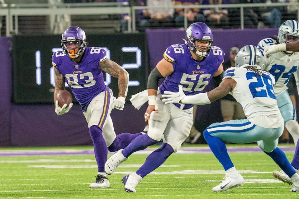 Minnesota Vikings tight end Tyler Conklin runs after a reception with center Garrett Bradbury blocking Dallas Cowboys safety Malik Hooker.