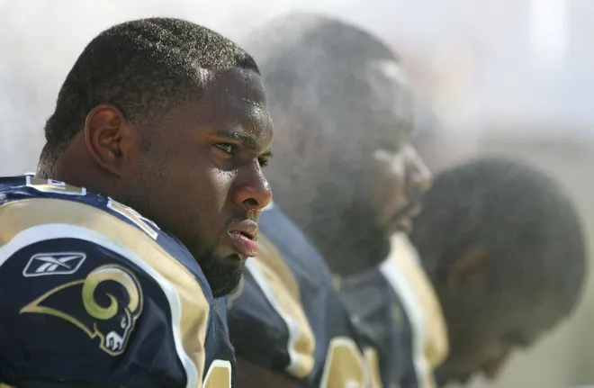 TEMPE, AZ - SEPTEMBER 18: (L-R) Defensive tackles Damione Lewis #92, Ryan Pickett #79 and Jimmy Kennedy #73 of the St. Louis Rams cool down on the bench under misting ventilators.