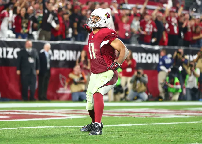Arizona Cardinals wide receiver Larry Fitzgerald celebrates after a first down catch in overtime against the Green Bay Packers in a NFC Divisional round playoff game.