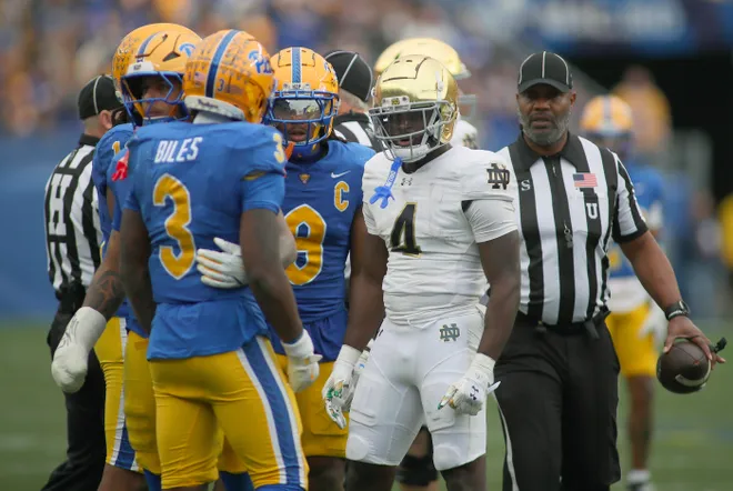 Notre Dame Fighting Irish running back Jeremiyah Love (4) and Pittsburgh Panthers linebacker Rasheem Biles (3) exchange words during the first half at Acrisure Stadium in Pittsburgh, PA on November 15, 2025.