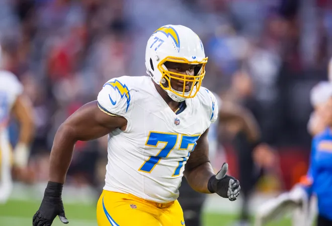 Oct 21, 2024; Glendale, Arizona, USA; Los Angeles Chargers guard Zion Johnson (77) against the Arizona Cardinals at State Farm Stadium. Mandatory Credit: Mark J. Rebilas-Imagn Images