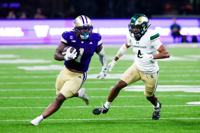 Aug 30, 2025; Seattle, Washington, USA; Washington Huskies running back Jonah Coleman (1) rushes against Colorado State Rams defensive back Jahari Rogers (4) during the fourth quarter at Husky Stadium. Mandatory Credit: Joe Nicholson-Imagn Images